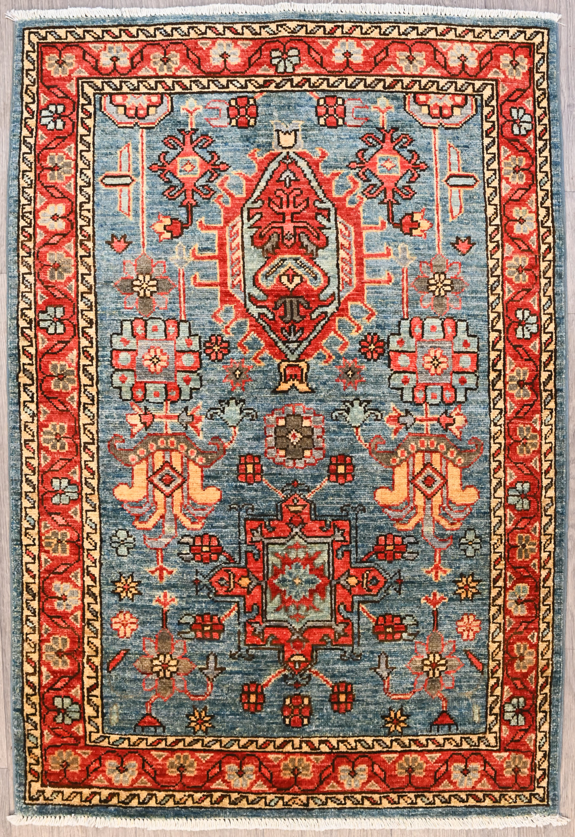 Authentic Handknotted Blue Afghan Ariana Chobi Wool Rug 126cm x 85cm woven in Shebarghan, Northern Afghanistan

Lovely Natural veg dyed colour palette depicts multiple elaborate medallion designs on a blue abrash background. The wide undulating border gives a finishing touch.

Stylish and practical Ariana tassels woven on the ends of the rug&nbsp;
Having a light and darker aspect is a trademark of Handmade Rugs