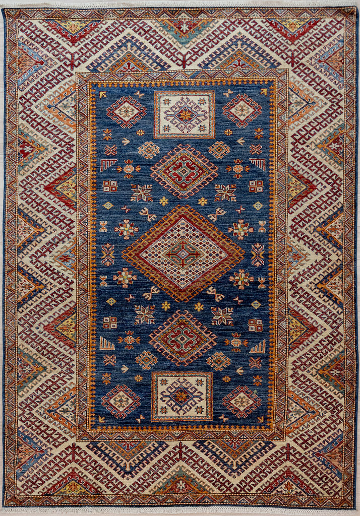 Authentic Hand Knotted Blue Afghan Super Kazak Wool Rug 232cm x 171cm woven by the tribal Kazak artisans of Northern Afghanistan
A vibrant central blue field is a backdrop to ornate medallions and cultural symbols all contained within a wide border featuring a meandering latch hook design.
Truly a one of a kind rug unmatched in design and all  achieved with non toxic dyes or undyed natural fleece.
Woven Using Premium Quality Wool which gives an unrivallled sheen to the pile
