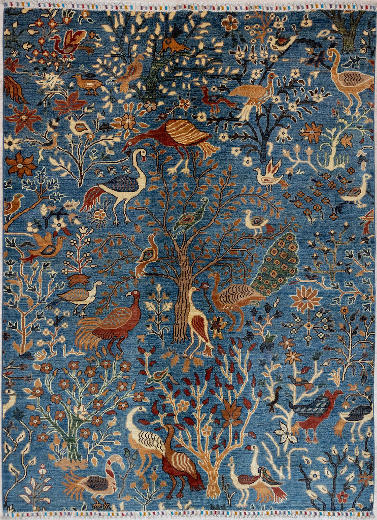 Authentic Hand woven Blue Pictorial Afghan Chobi Wool Rug 199cm x 152cm&nbsp;made by local artisans of Afghanistan

Beautiful teal blue centre combined with multicoloured birds with multicloured plumage resting in and under flowering fruit trees.
A one of a kind piece reflecting the joy of the organic rural lifestyle.
The artisans respect their environment using natural and only non toxic dyestuff such as Indigo. The weavers are heirs to processes and recipes from the past.
