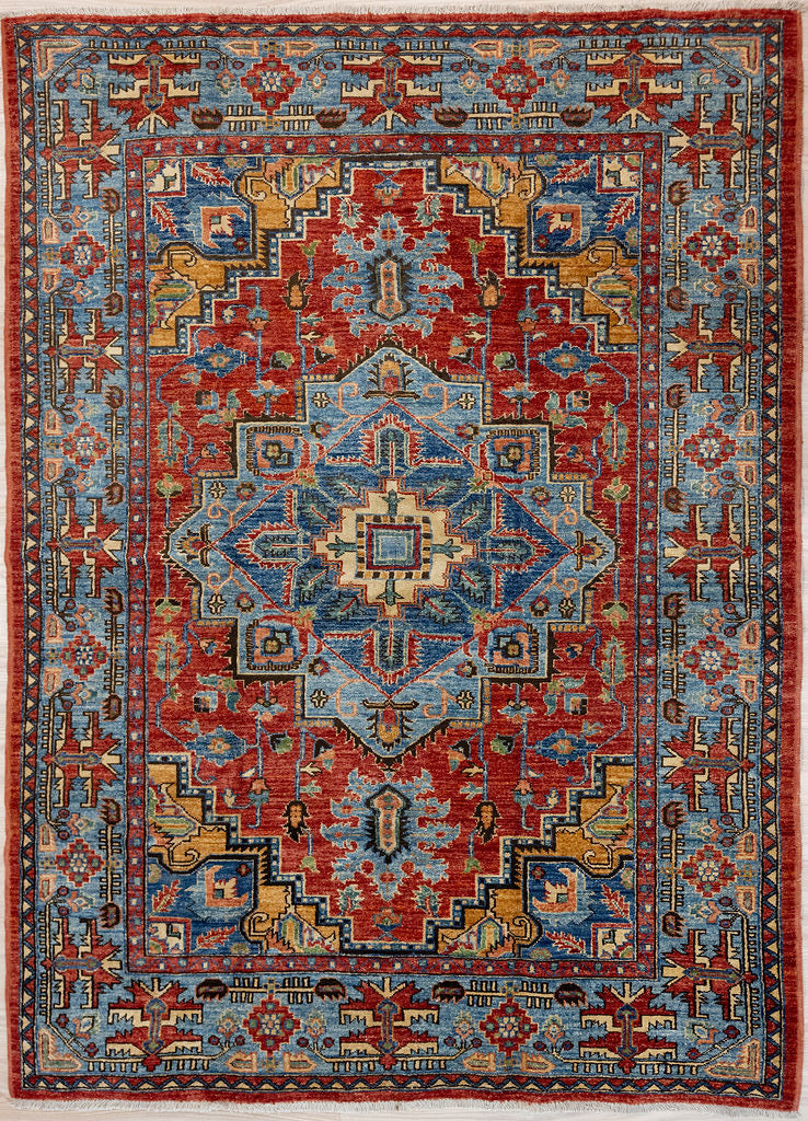Authentic Handknotted Blue Red Afghan Chobi Wool Rug 203cm x 146cm woven in Central Asia
A unique adaption of traditional rug design bringing a touch of modern contemporary to your home.
Lovely colour palette of red field along with Blue architectural medallions and a mix of other natural dyed colours pink, mustard, burgundy in a wide blue border.