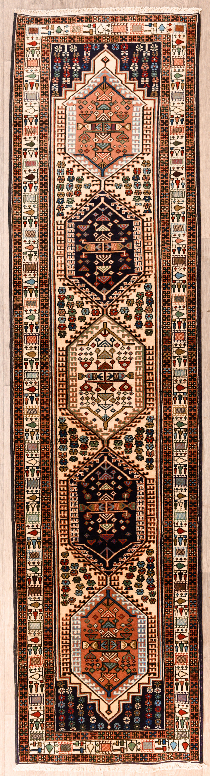 Authentic Handknotted Cream Persian Ardebil Wool Runner 303cm x 76cm
White/Cream field colour tone with multicolour medalions throughout
Pictorial motifs woven through the centre and; border of the Runner