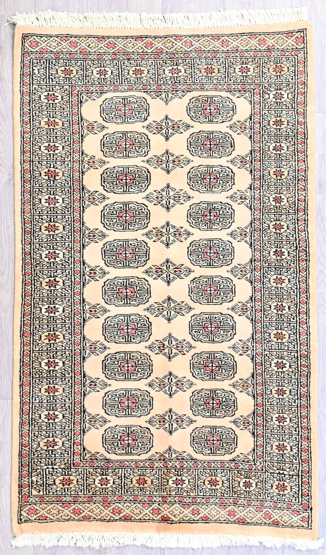 Authentic Handknotted Wool Cream &amp; Peach Bokhara Rug woven in Central Asia
This rug is made with beautiful soft silk feel wool