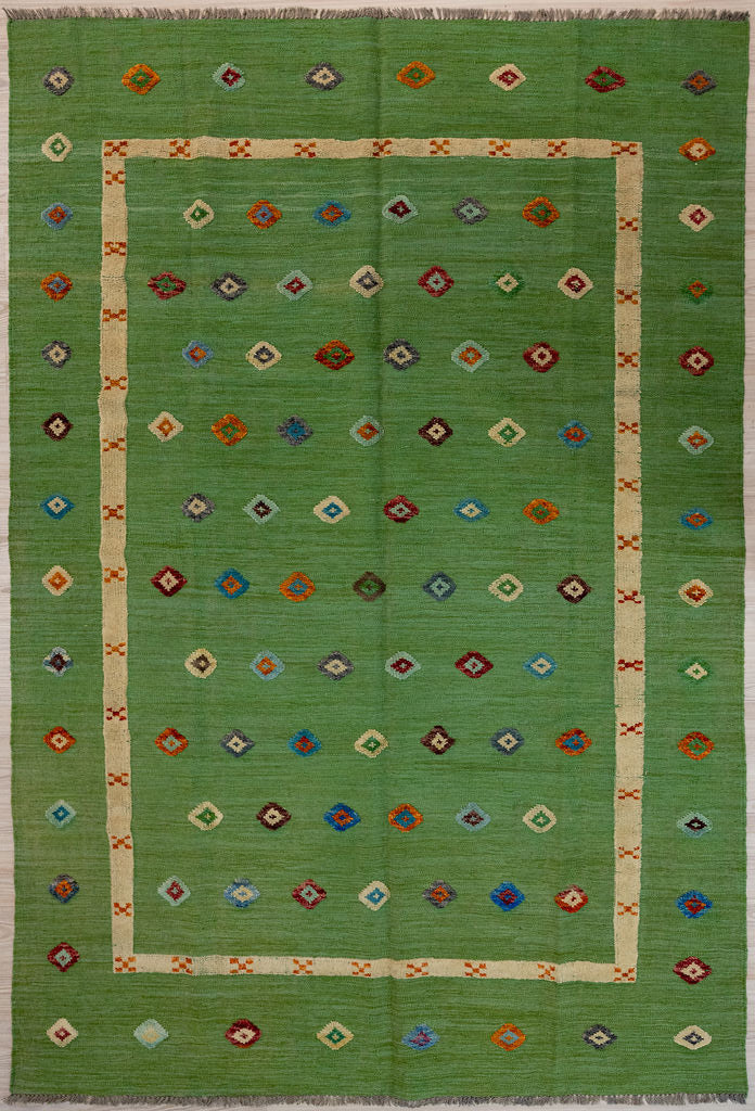 Green Barjasta Afghan Wool Kilim 292cm x 202cm
Guaranteed Original Persian Kilim Pure Wool with textured wool pile diamonds of different colours and a border on a green abrash wool background.&nbsp;
Texture is formed by deliberately spinning together different dye batches
Durable and Wear Resistant Suitable for High Traffic Areas