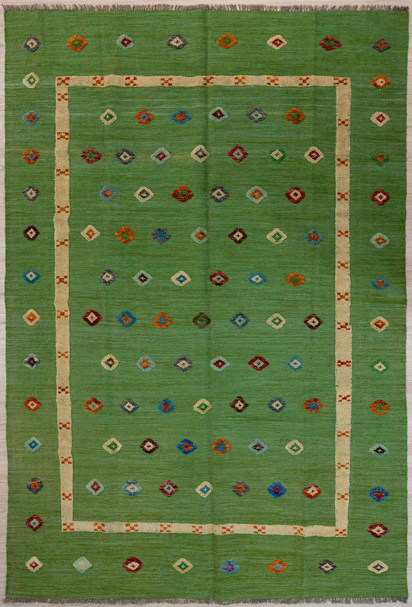 Green Barjasta Afghan Wool Kilim 292cm x 202cm
Guaranteed Original Persian Kilim Pure Wool with textured wool pile diamonds of different colours and a border on a green abrash wool background.&nbsp;
Texture is formed by deliberately spinning together different dye batches
Durable and Wear Resistant Suitable for High Traffic Areas
