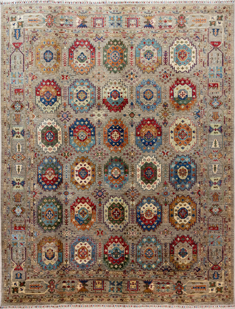Authentic Handknotted Grey Afghan Suzani Chobi Wool Rug 309cm x 232cm woven in Shebarghan, Northern Afghanistan
A grey field supports&nbsp; multicoloured Filipa type guls all over. In this rug the negative spaces between guls are filled with delicate atomic or Nordic feel, branching motifs giving the impression of two rugs in one.
Beautifully decorated 'Ariana' tassles on each end
Colour tones all made from local vegetable/plant based dyes