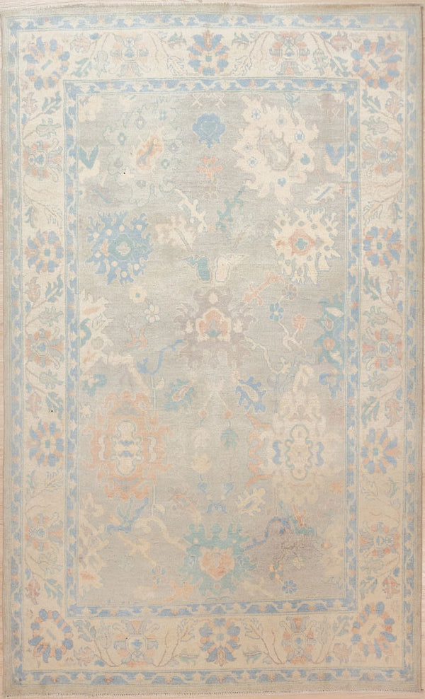 Authentic Hand Knotted Grey Muted Afghan Oushak Chobi Wool Rug 268cm x 172cm
This rug has a misty Muted Grey background&nbsp; supporting cloudy semi abstract forms in the pale blues pinks and creams of a misty morning sunrise.
This rug is both floral and geometric at the same time with subtle colour tones all made with natural vegetable dyes keeping your air quality healthy.
Oushak Design light toned rug brightens your interior and opens your space.