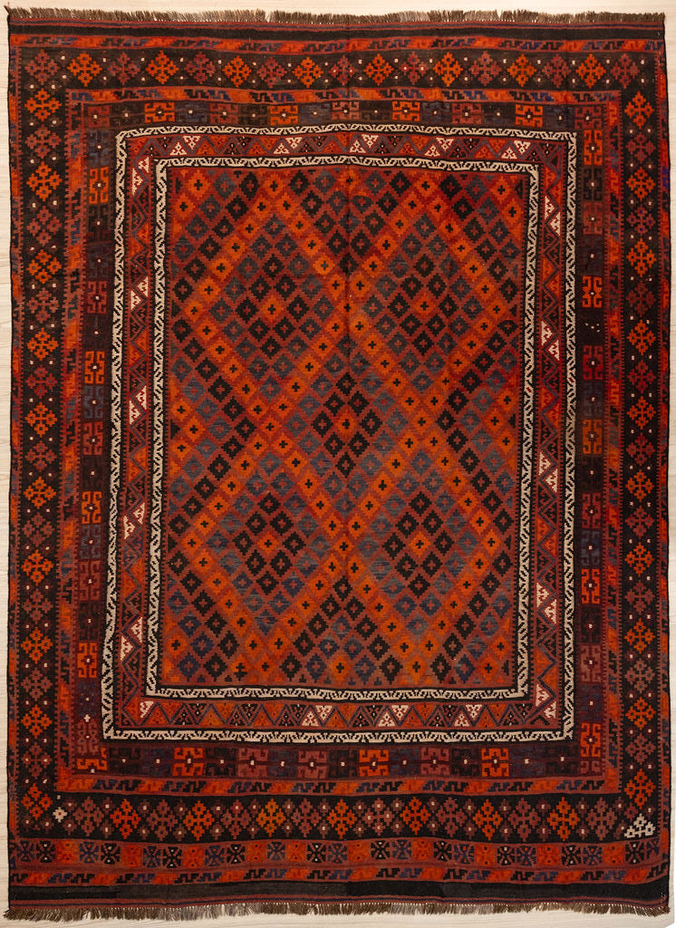Authentic Hand knotted Vintage c.1970's Persian Wool Kilim 324cm x 250cm woven in Central Asia
Aged gracefully and in immaculate condition. Earthy tones with strong reds and oranges can compliment a Mid Century or casual boho home.
Kilims are a flat-weave rug used for over a millennium in Tribal areas of Central Asia &amp; Anatolia. Historically used by nomads as floor covering or tent lining they are able to be carried on horseback because of their lightweight nature. Perfect for a summer, or rural set