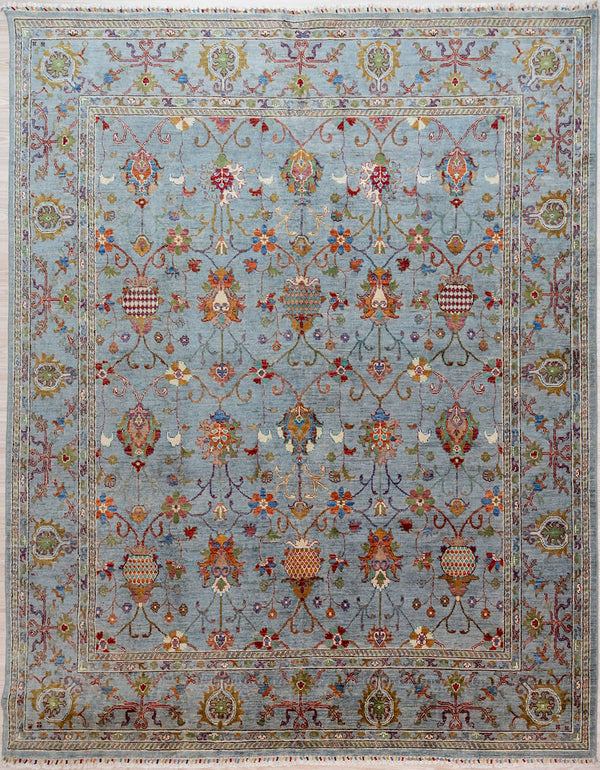 Hand knotted Ice Blue Afghan Sultani Chobi Wool Rug 295cm x 248cm woven in Mazar, Northern Afghanistan by creative female artisans who are experts in natural dyes
A one of-a-kind romantic, oriental rug expressing the joy of a snowmelt Spring within a restrained contemporary paler colour palette
Featuring a cool ice blue background this rug is at home in any modern architectural setting or near water.

Ariana tassels woven on the top and bottom edges, by female artisans