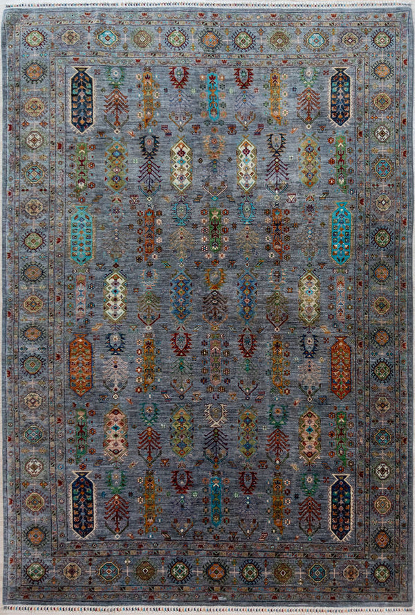 Authentic Large Handmade&nbsp;Grey Pictorial Afghan Suzani Chobi Wool Rug 346cm x 252cm made by local artisans of Sehbarghan, Northern Afghanistan
Tree of life and other motifs and symbols drawn from cultural memory adorn this large hearth warmer.
A background of natural grey Ghazni mountain sheep's'wool displays contains a full range of beautiful natural veg dyed colours accented with contrasting flashes of natural cream.

A one of a kind example of dyeing and weaving artistry