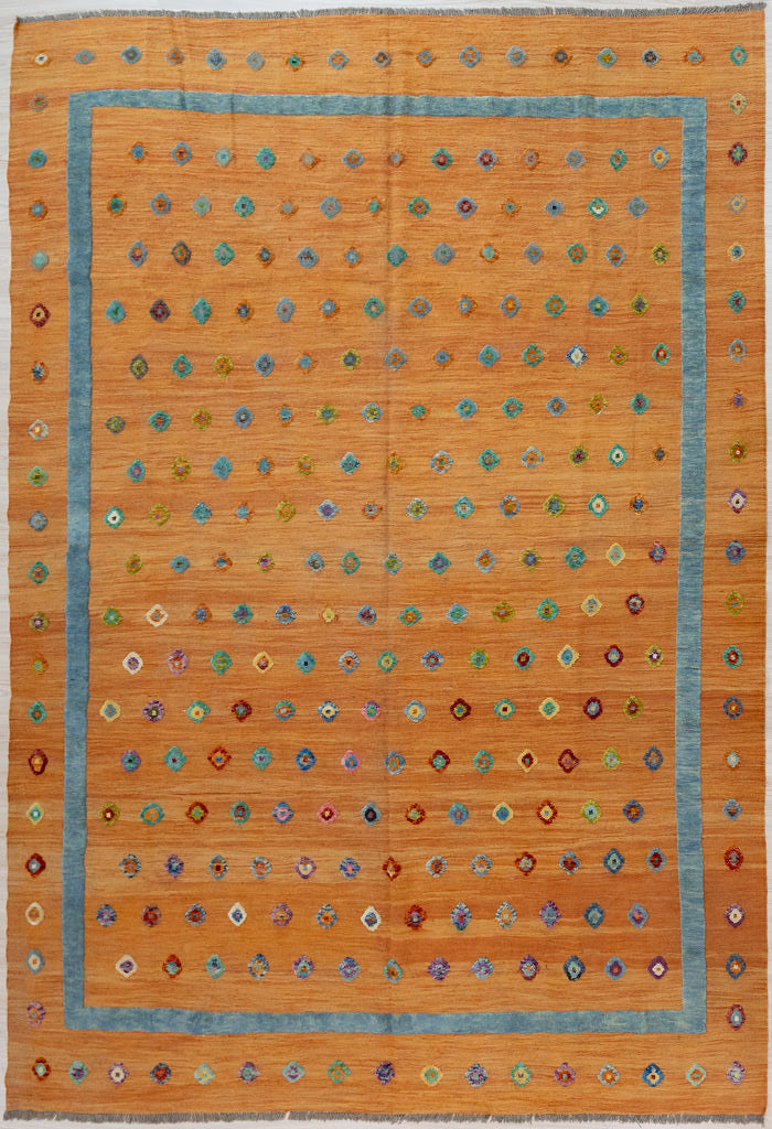 XL Rare Orange Orange Barjasta Wool Kilim 387cm x 284cm
Guaranteed Original Pure Wool with textured raised wool pile diamonds of different colours and a turquoise border on a burnt orange abrash wool background.
Texture and colour variation is formed by deliberately spinning together wool from different dye batches
Durable and Wear Resistant Suitable for High Traffic Areas
All Colours in This Piece Originate from Natural Vegetable Dyes