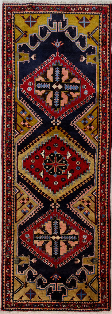 Guaranteed Original Vintage Persian Hamadan Wool Runner 310cm x 112cm woven in Central Asia.
This beauty is so interesting, It has a theme of large latch hook motifs in golden mustard edged with cool beige dyed with pomegranite skins and iron. Then the pattern goes fractal with smaller latch hook edgings. Lovely pink in the medallions and stylised chrysanthemums as typical of Hamadan. See the combs in the corners? Thats the weaving tool used to firmly press down the pile.