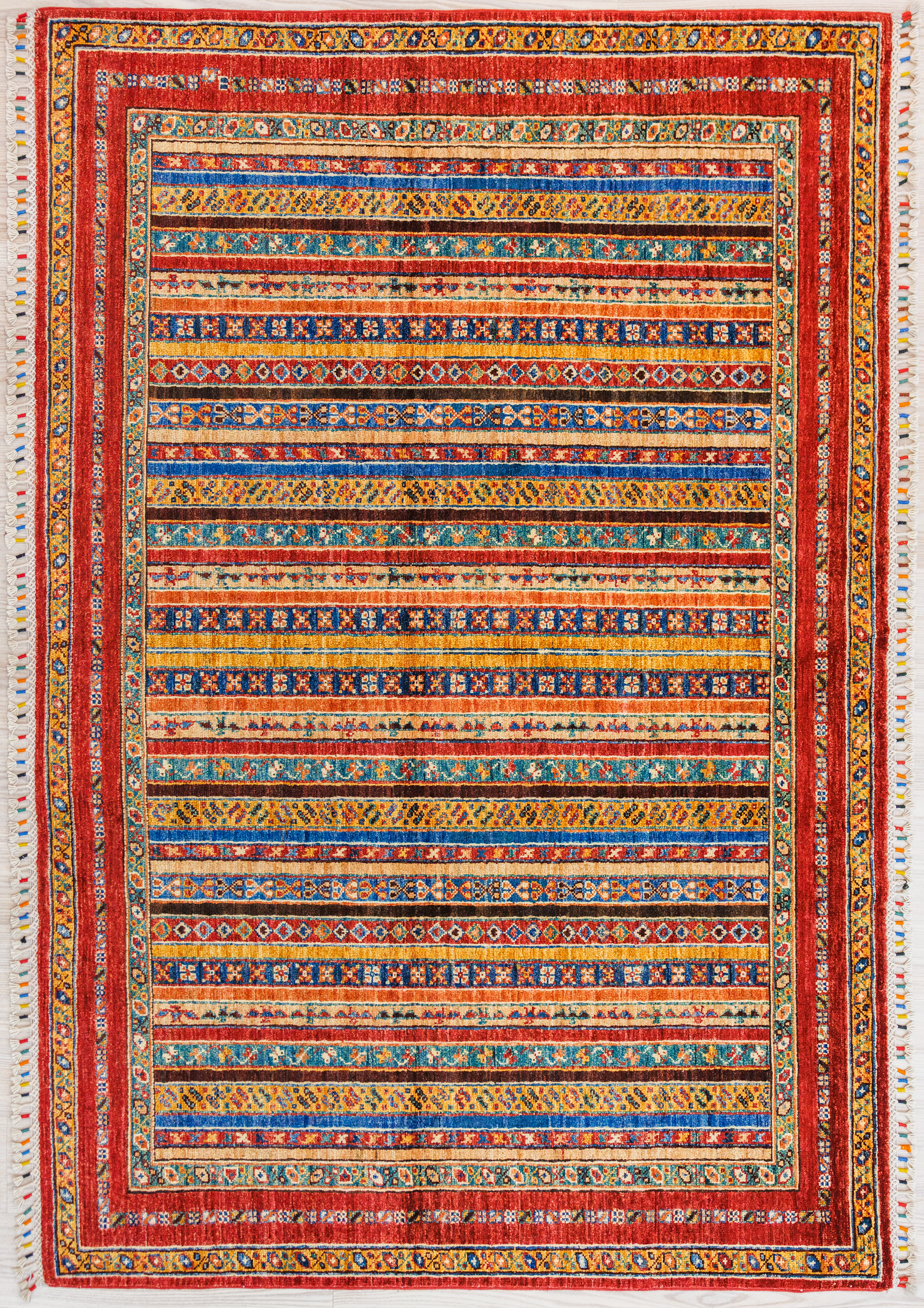 Authentic hand woven Multicolour Afghan Khurjin Chobi Wool Rug 204cm x 154cm, woven in Northern Afghanistan. Beauitful tribal aztec style design all over, suitable for both traditional and contemporary interiors
Ariana multicolored tassels for authenticity
