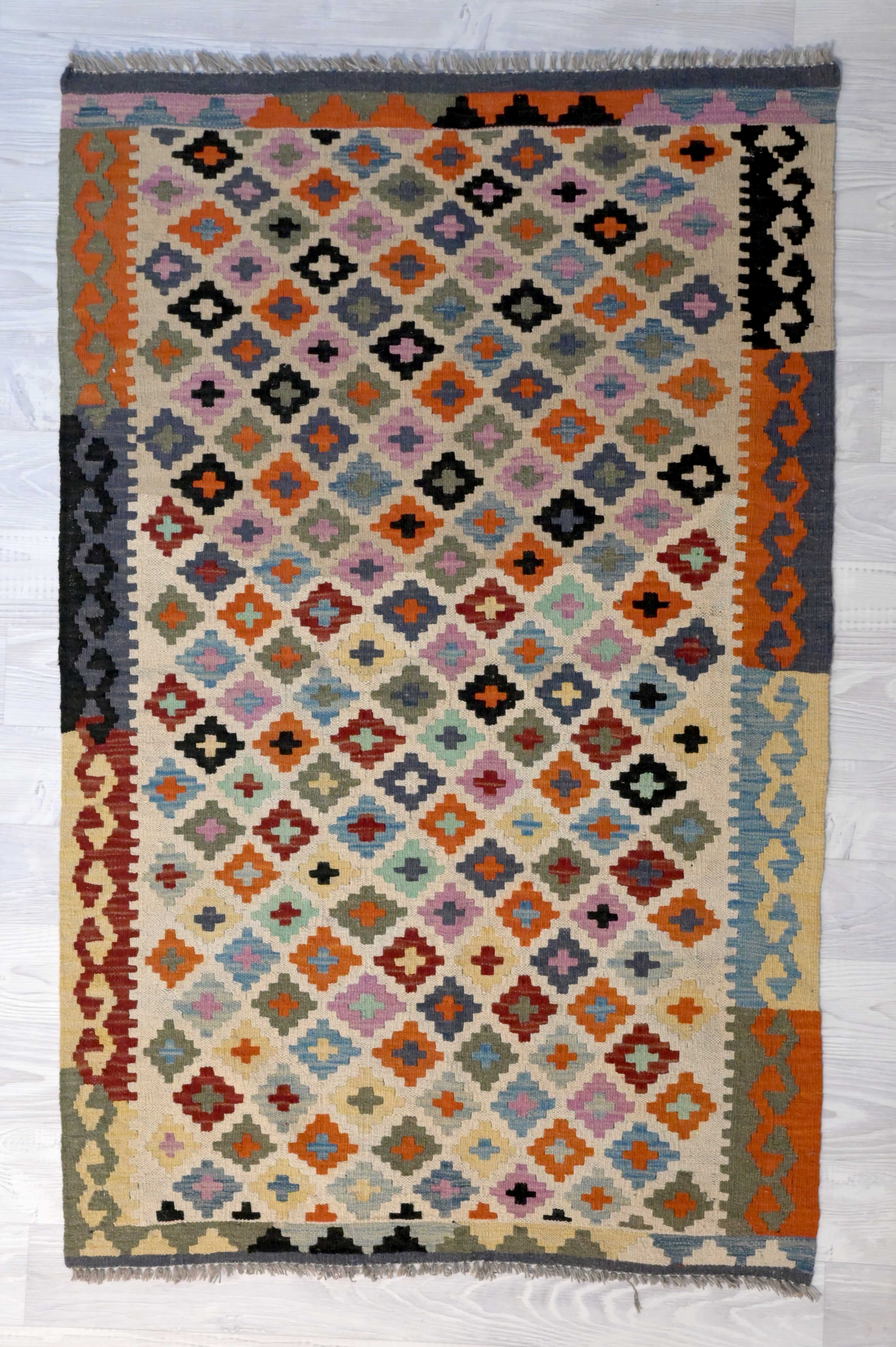 Multicolour Boho Kilim Rug 151cm x 99cm with repeating design reminding one of retro granny squares. 