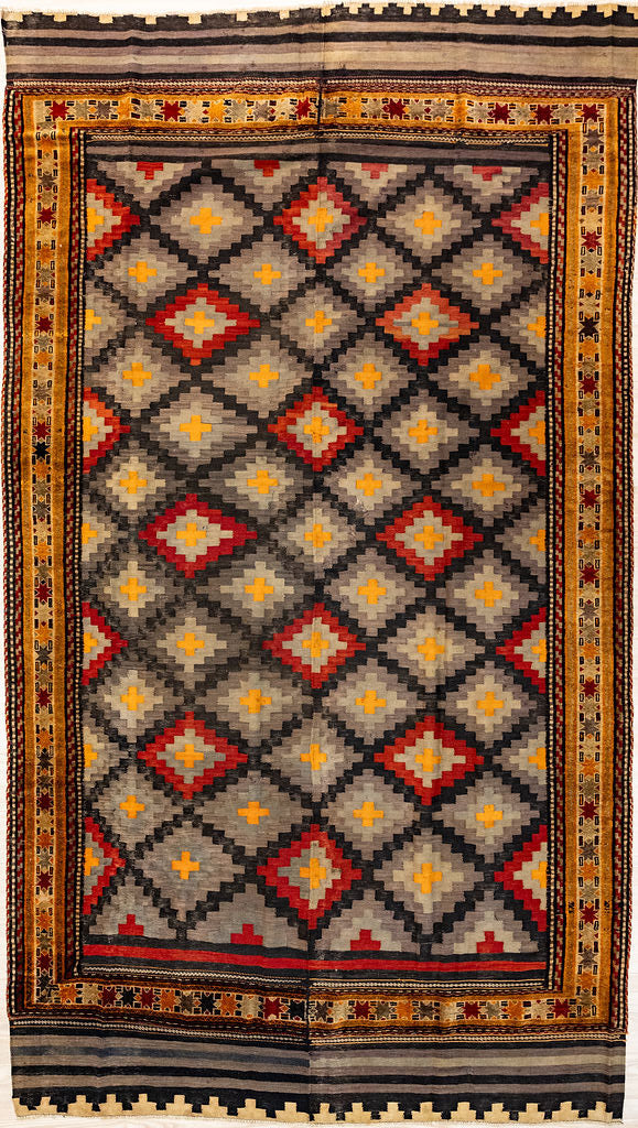 Authentic Handknotted Multicolour Vintage Persian Wool Kilim 288cm x 190cmIn in harmonizing colours of deep brown and burnt orange, yellow and pale indigo&nbsp; this rug has a cross hatched centre field and an elaborate unusually detailed border
The colour tones have aged gracefully over the decades and the wool has softened. fringes are short and practical.Kilims are a light flatweave reversible rug used by the nomadic tribes of Central Asia. These portable rugs can also go with you