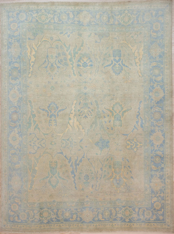 Authentic Hand Knotted Muted Blue Afghan Oushak Chobi Wool Rug 300cm x 246cm
This rug has a misty Muted variegated background colour with an already antique vintage look. Shapes of Iris, meaning wisdom and acanthus leaves, symbolising immortality appear in this design within a blue floral border.
The subtle colour tones are all made with natural vegetable dyes or naturally coloured wool, keeping your air quality healthy.
Oushak Design light toned rug brightens your interior and opens your space.

