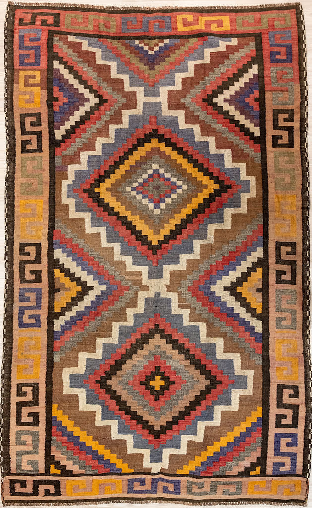 Authentic Muted c.1960's Vintage Persian Wool Kilim 265cm x 160cm in soft ochre,&nbsp; pale indigo, soft pinky red and warm beig. All natural veg dyes.
This&nbsp; one off design rug features a border of greek key motif also called meander pattern. This portable rug really can also go with you on&nbsp; your meanders and travels, or on picnics or camping trips
The colour tones have muted over the decades and the wool has softened. Fringes are short and practical.