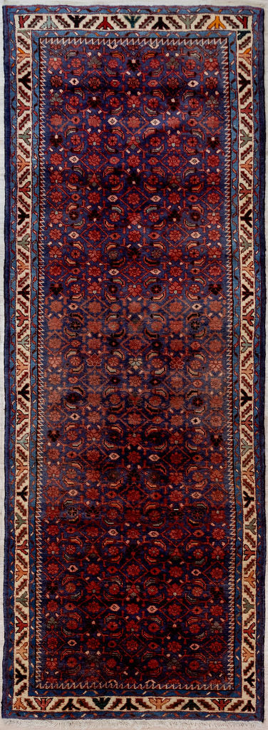 Guaranteed Original Navy Vintage Persian Hamadan Wool Runner 295cm x 110cm woven in Central Asia.
An all over pattern of Spring blossoms in reds, pinks and cream on deep purple blue indigo. A few green leaves peeping through to follow the blossoms. A border of bare tree trunks completes the rural seasonal theme.
Having a light and darker aspect side is a trademark of Handmade Rugs
Durable and Wear Resistant Suitable for High Traffic Areas