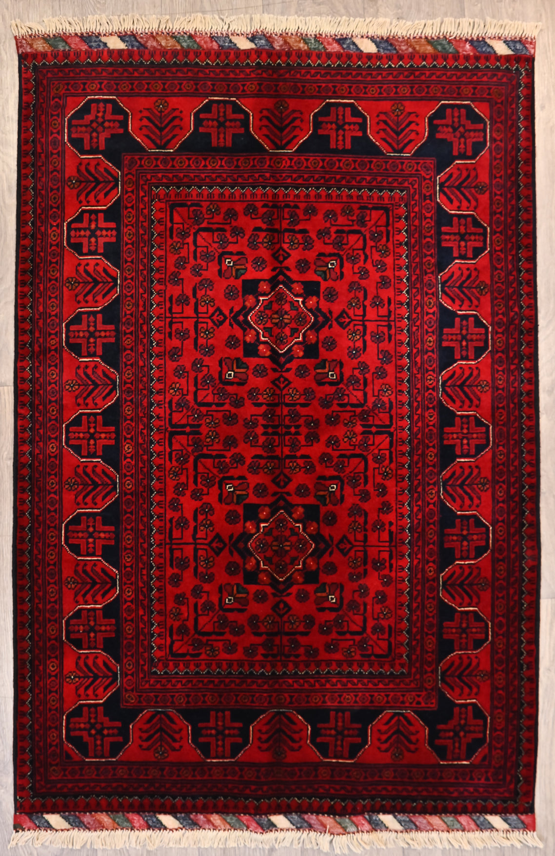 Authentic Hand knotted Red Afghan Kundus Wool Rug 150cm x 100cm
A lovely smaller rug with a border of alternating niches where red and black alternate between the background and the design within the niche, cleverly using the concept of positive and negative space. If you learned this concept in art school here it is in action. Weavers are very creative
This rug is in fine condition, showcasing the expertise of the weaver in creating an object of lasting beauty.