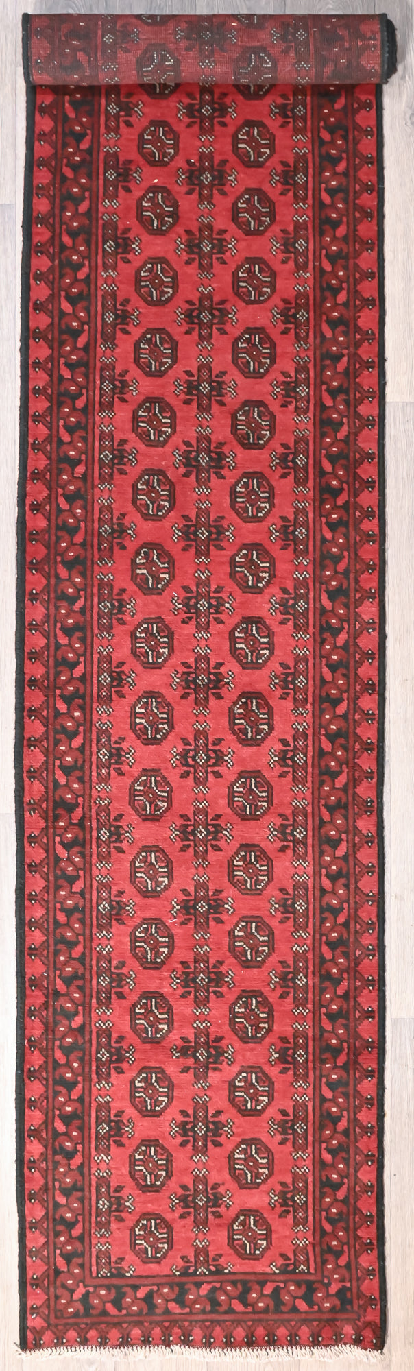 Red Afghan Turkoman Bokhara Wool Runner 400cm x 80cm an intricate fine border contains repeating geometric Gul designs