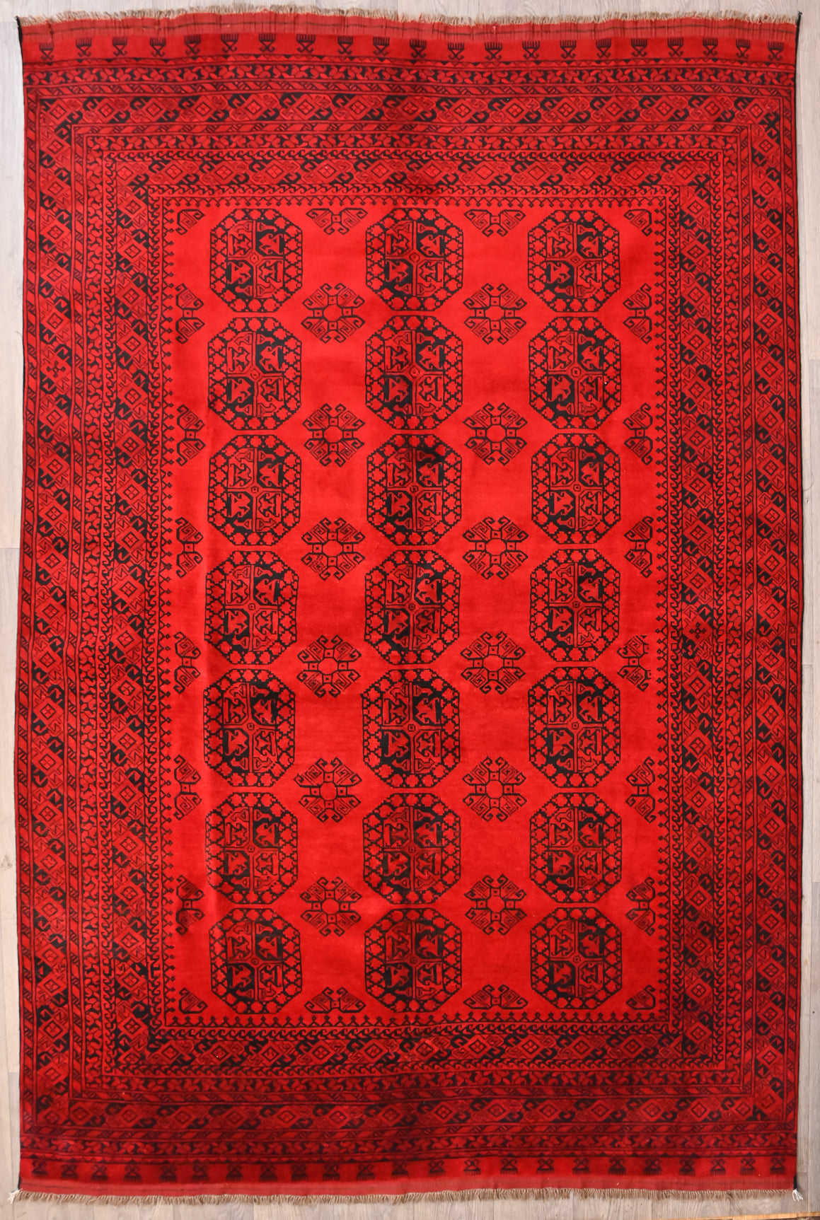 Authentic handknotted Red Afghan Turkoman Filpa Wool Rug 291cm x 189cm
The elegant repeating Bokhara motifs or Guls are slightly different in design in each unique rug and functioned like a weaver's signature.
Glowing traditional madder root red and black design
Having a light and dark aspect is a trademark of Handmade Rugs
Durable and Wear Resistant Suitable for High Traffic Areas