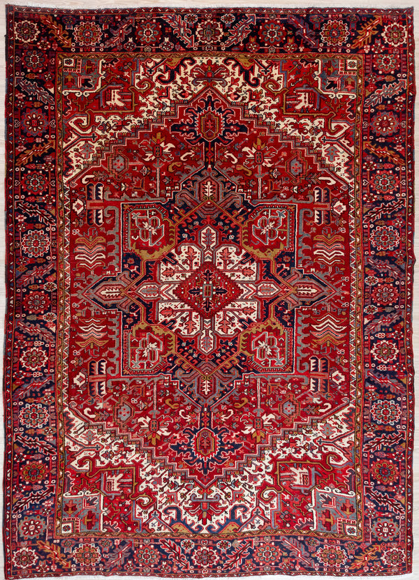 Authentic Hand Knotted Red Persian Heriz Wool Rug 350cm x 260cm &nbsp;Woven in the city of Heriz, in the northwest of Iran known for its unique architectural style villages
Woven circa 1970's, Heriz rugs are made from quality wool. Mountain sheep dine on plants high in copper making for extremely durable wool
Known for its larger than life bold geometric designs with centre medallion.
Beautiful combination of red, pink, indogo and tones of brown harmonise in this gracefully aged traditional rug.