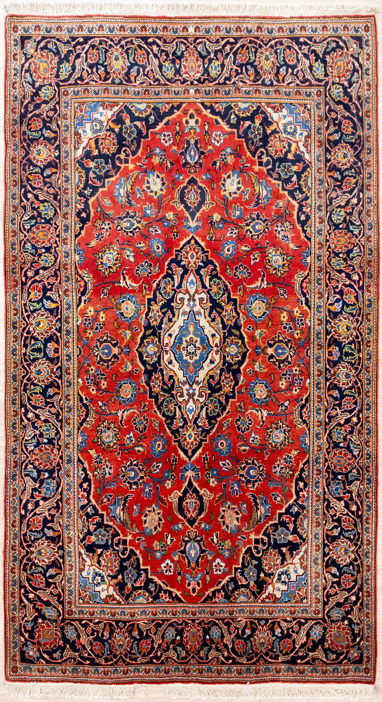 Authentic Handknotted Red Persian Kashan Wool Rug 245cm x 142cm
A rather regal Rust Red field tone is combined with a narrow, oval ,cream and indigo blue medallion. This is set within a lovely complex floral border and four corner spandrels picked out in cream and navy.
Woven by the artisans of Kashan, a suave traditional accent piece in superb condition and great price to build your persian rug collection today..&nbsp;

Suits high traffic areas