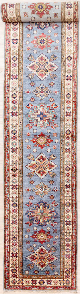 Authentic Hand Woven Steel Blue Afghan Super Kazak Wool Runner 594cm x 80cm
Beautiful blue &amp; cream tones all over made from local vegetable &amp; plant dyes

Central Medallions stand out in Marled Red and Gold accents&nbsp;
Woven Using Premium Quality Wool gives an Unrivallled Shine Off the Pile
Originating from the Caucaus Region, the Kazak Design is now Mastered by the Generational Weavers of North-Central Asia