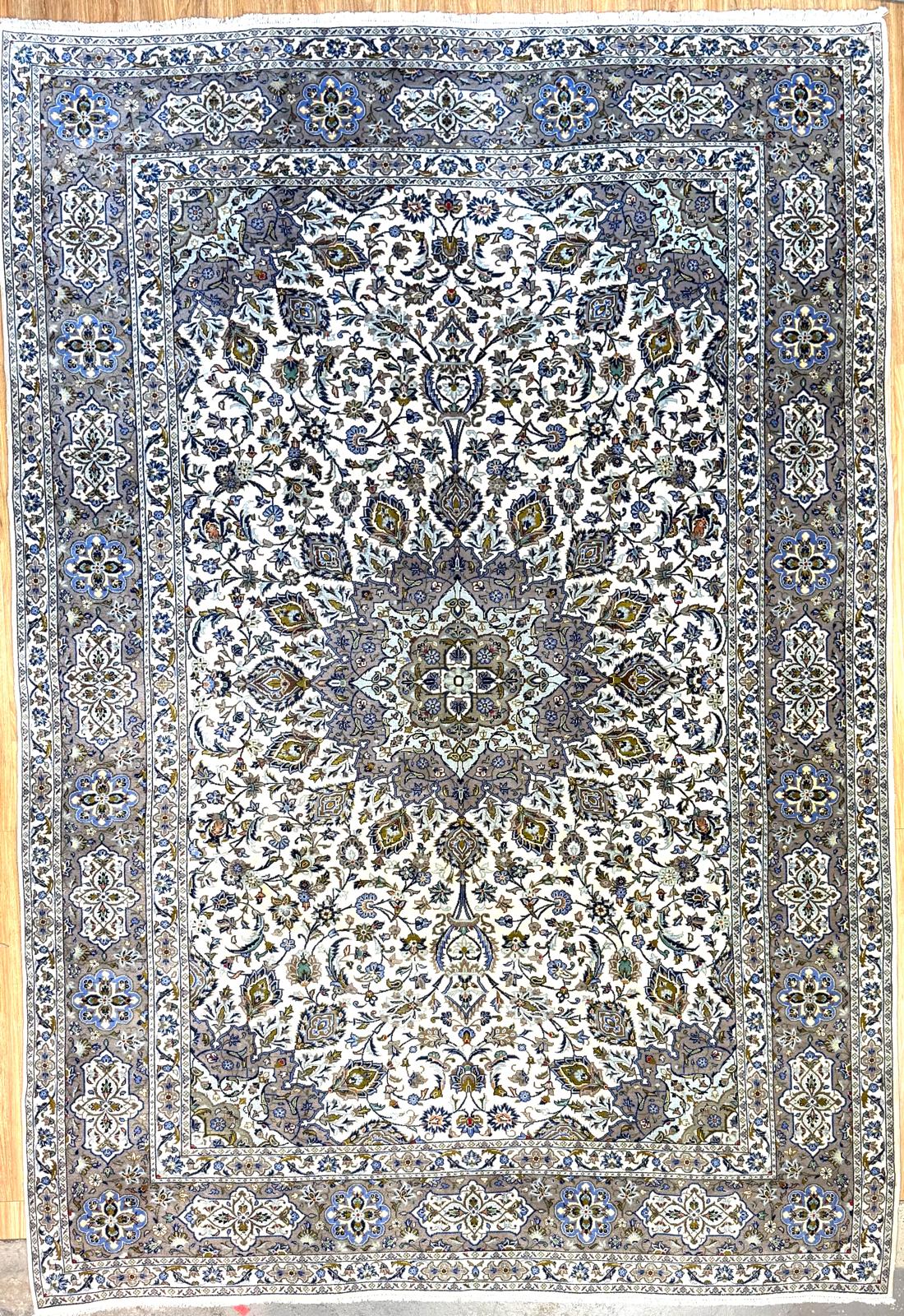 Guaranteed Original Vintage Beige Persian Kashan Wool Rug 405cm x 290cm in the city of Kashan, Iran
Beautiful traditional design with centre medallion
Rare colour mix of green, olive, blues and beige/white
Having a light and dark side is a trademark of Handmade Rugs
Durable and Wear Resistant Suitable for High Traffic Areas
All Colours in This Piece Originate from Natural Vegetable Dyes