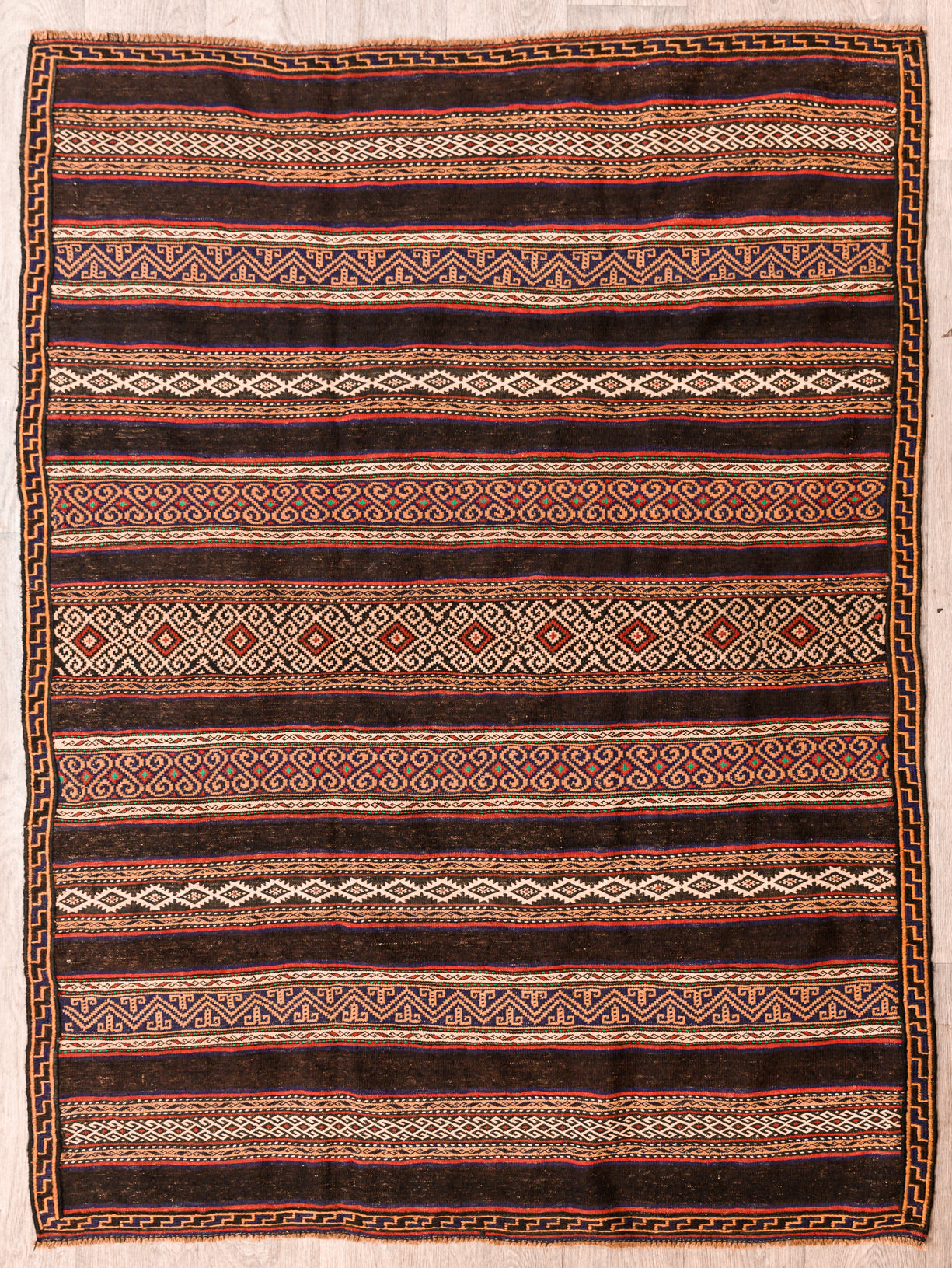 Authentic hand made Vintage Persian Wool Sumak 197cm x 150cm

Colour dyes made from Indigo and other local ground herbs  local berries
Durable and Wear Resistant. Has weight and hugs floor
Rare flashes of green.
Interesting stripes in complex woven patterns