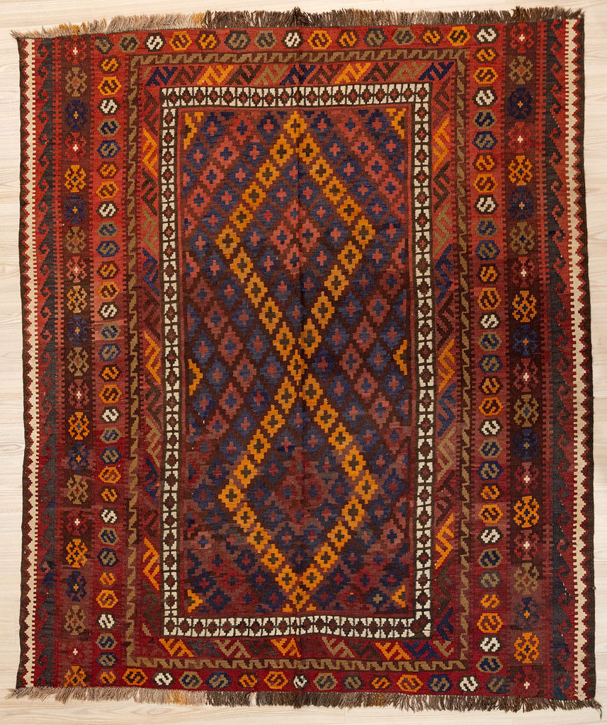 Authentic Vintage c.1960's Persian Wool Kilim 237cm x 207cm in soft ochre, pale indigo, soft pinky red and warm beige. All natural veg dyes.
This one off design rug features a border of greek key motif also called meander pattern. This portable rug really can also go with you on your meanders and travels, or on picnics or camping trips
Six ornamental borders enclose a central large scale design.
The colour tones have muted over the decades and the wool has softened. Fringes are short and practical