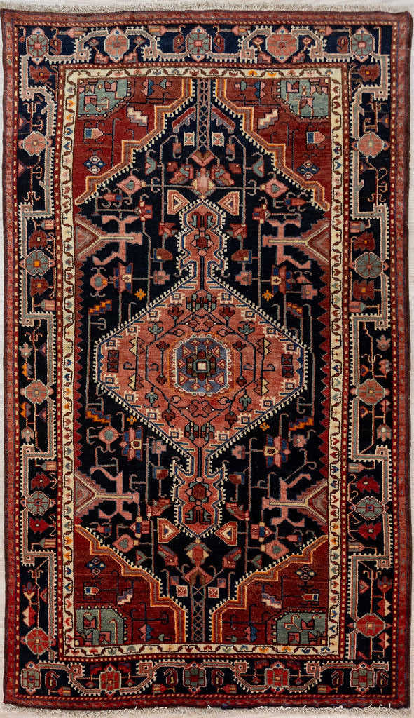 Bring a bold touch of Persian heritage into your home with our Vintage c.1970's Persian Hamadan Wool Rug 200cm x 116cm
Handknotted in the ancient city of Hamadan, this rug boasts a classic pattern and is made of pure sheeps wool for a soft, luxurious feel under your feet.
Rusty red and indigo with a purplish cast are typical colours for this rug style. The cream is clear and bright. All colours are natural vegetable dyes with techniques passed down over generations

Durable and Wear Resistant, Suitab