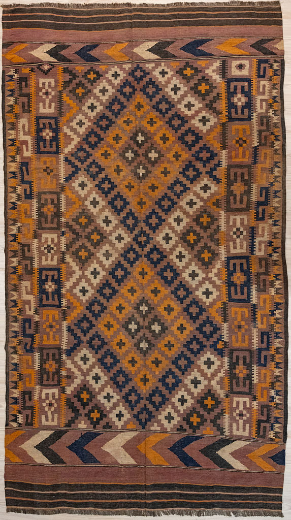 Authentic Handknotted Vintage c.1970's Persian Wool Kilim 330cm x 192cm woven in Central Asia
Aged gracefully and in immaculate condition
Kilims are a flat-weave rug used for over a millennium in Tribal areas of Central Asia &amp; Anatolia. Historically used by nomads as floor covering, tent covering &amp; on horseback for its lightweight nature
Perfect for a summer rug, coastal or to bring more character and life into your interior. With its subtle browns ,orange and tan colours will fit with modern or MCM