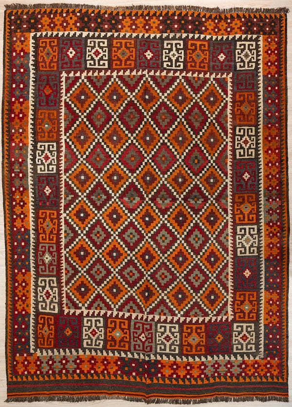 Authentic Handknotted Vintage c.1980's Persian Wool Kilim 291cm x 224cm
In popular midcentury colours of reds browns and orange this rug has a cross hatched centre field and an elaborate border
The colour tones have aged gracefully over the decades and the wool softens