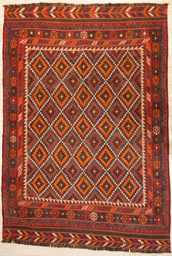 Authentic Handknotted Vintage c.1980's Persian Wool Kilim 290cm x 214cm
In clear colours of reds browns and orange this rug has a cross hatched centre field and an elaborate border
The colour tones have aged gracefully over the decades and the wool softens
Kilims are a light flatweave reversible rug used for over a millennium by the nomadic tribes of Central Asia