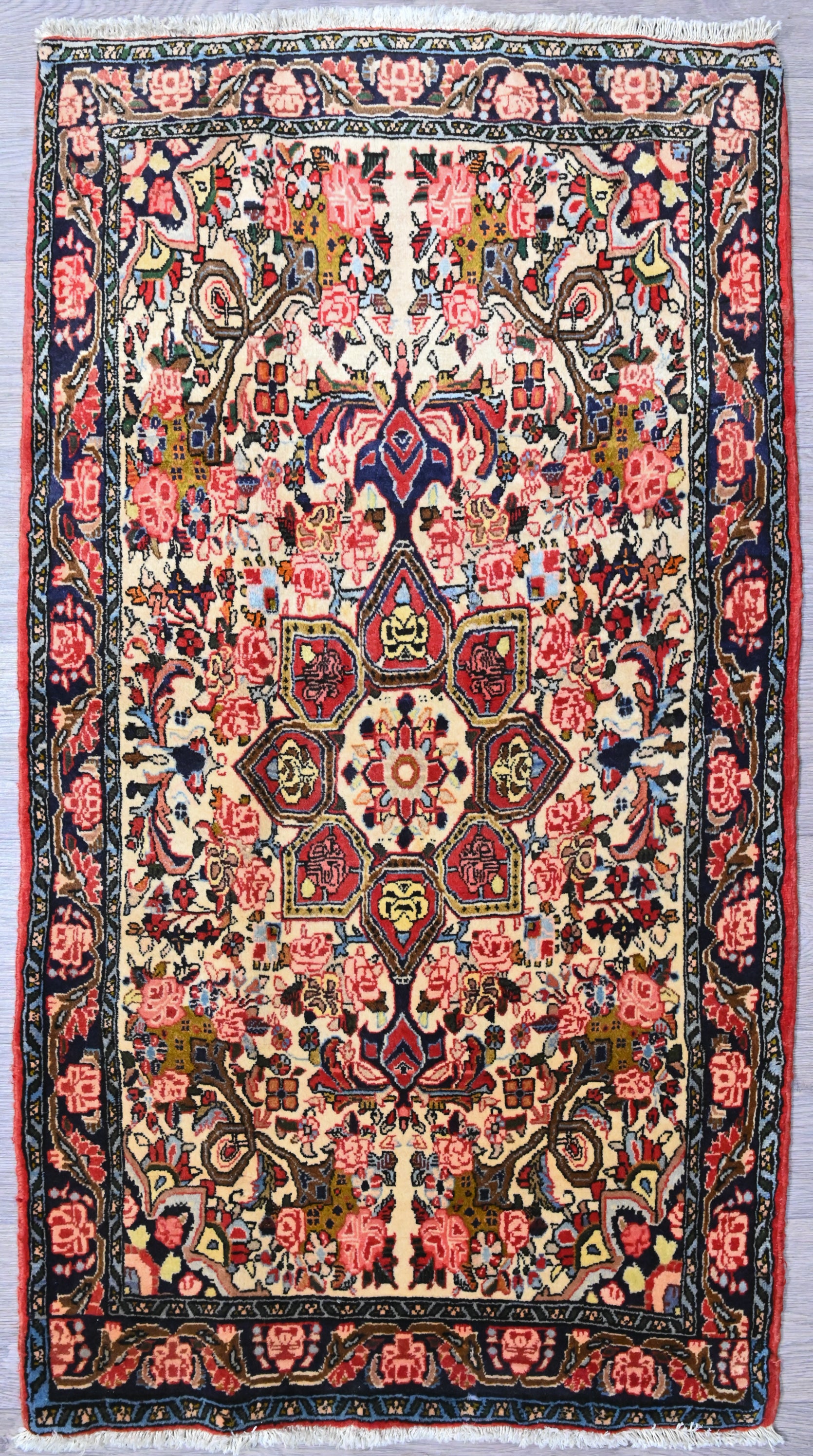 Guaranteed Authentic Vintage c,1980's Persian Bijar Wool Rug 103cm x 78cm
High knot densely woven rug with a thick pile
Finely hand woven by skilled artisans, strong &amp; durable construction to last the decades
Beautifully combination of browns, pinks and cream on a centre medallion with a navy border
Having a light and darker aspect is a trademark of Handmade Rugs
Durable and Wear Resistant Suitable for High Traffic Areas