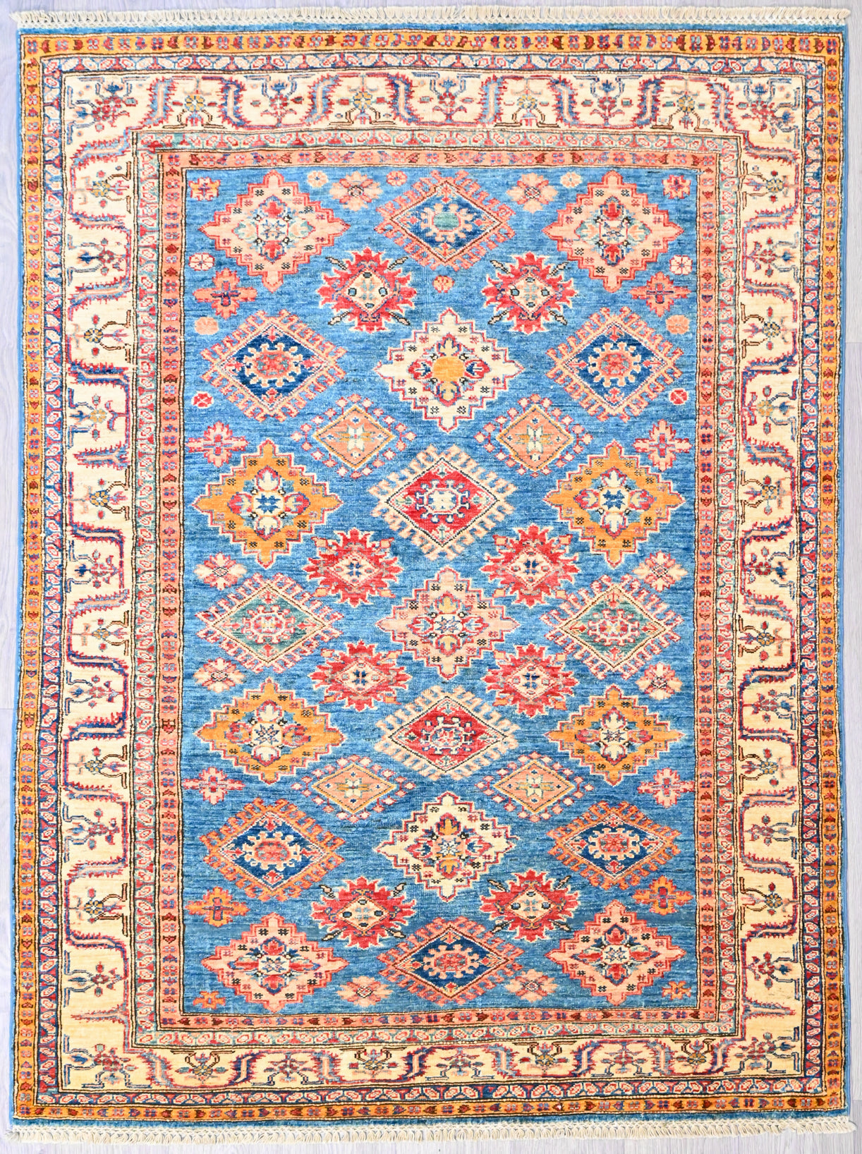 Authentic Handknotted Wool Blue Fine Afghan Super Kazak Rug woven in Central Asia
"Super" in super Kazak refers to the super fine knotting and the superior wool pile with its soft lustrous sheen.
Having a light and dark aspect is a trademark of Handmade Rugs
Durable and Wear Resistant Suitable for High Traffic Areas