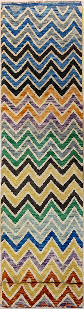 Authentic Hand Knotted&nbsp; Multicolour Afghan Boho Kilim Wool Runner 674cm x 81cm in a zigg zag style. May blend with Missoni decor
Kilims are a flatweave runner used for over a millennium in Tribal areas of Central Asia and Anatolia. Historically used by nomads as floor covering, tent covering carried on horseback for its lightweight nature
Perfect for a summer runner, coastal or to bring more character, into your interior